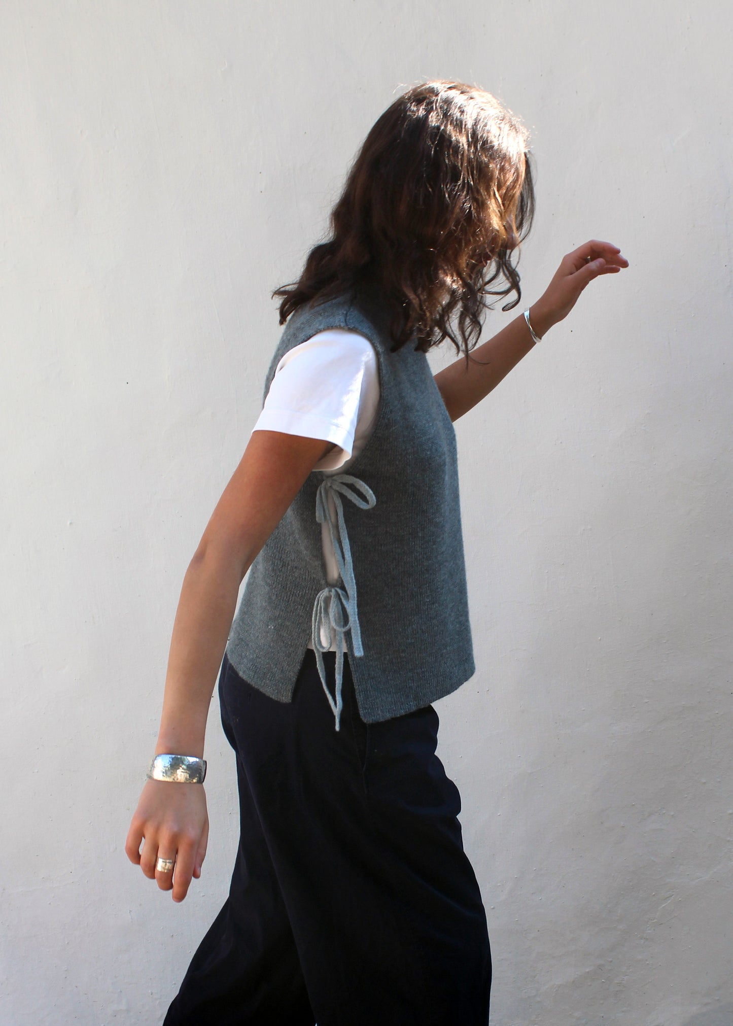 Model in blue wool vest.