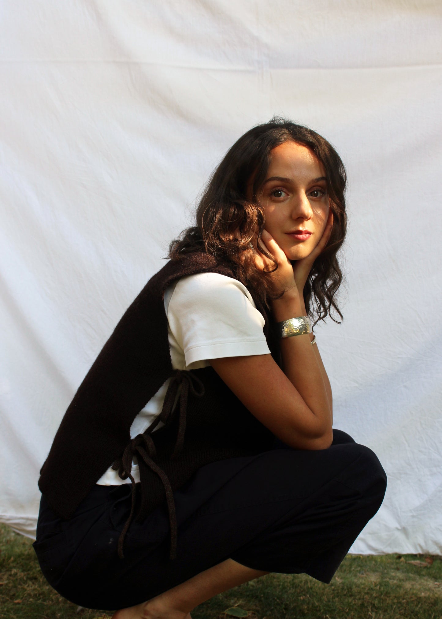 Model in brown wool vest. 