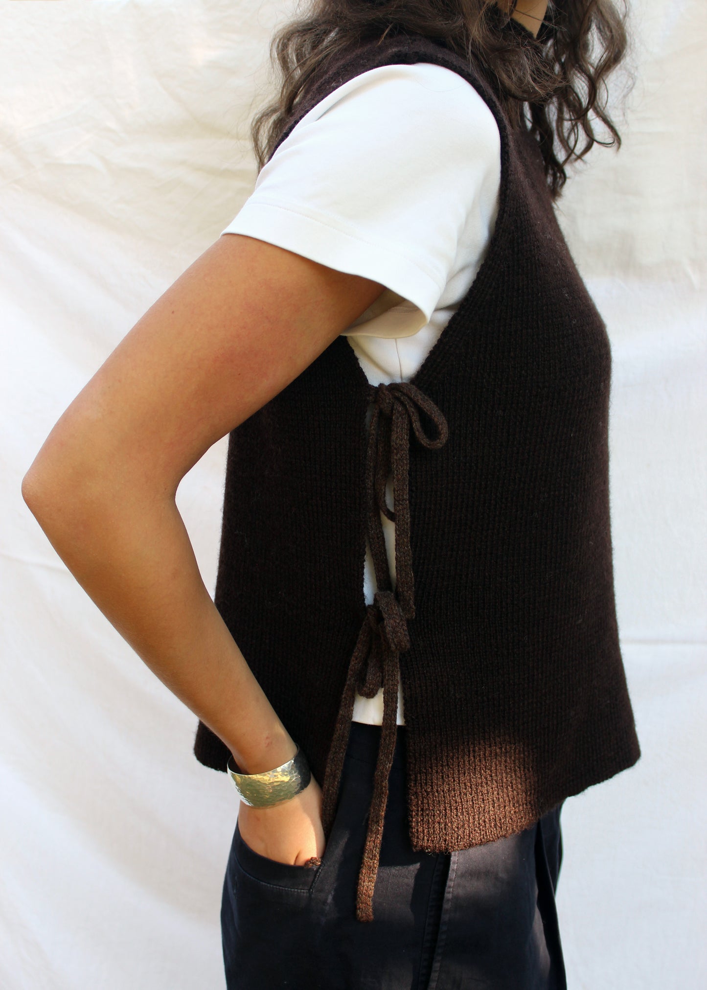 Model in brown wool vest. 