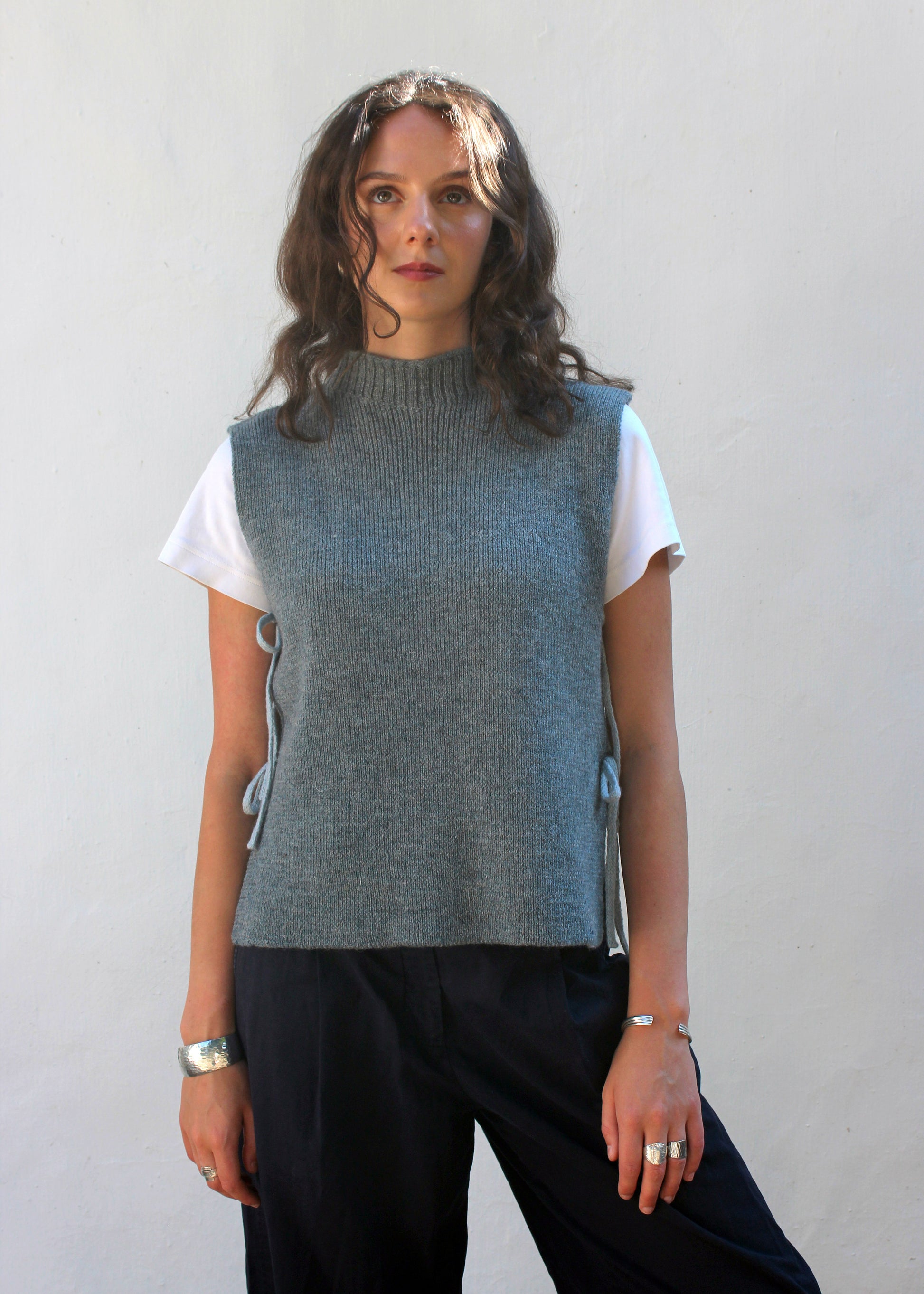 Model in blue wool vest. 